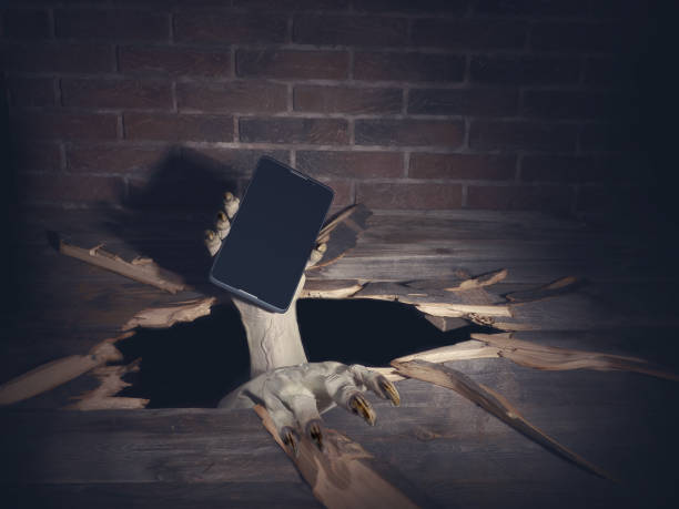 istock Zombie hand through hole cracked in rustic wood.Halloween theme 1038691598