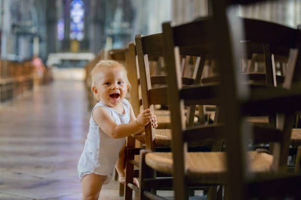 Little child in big cathedral Little child in big cathedral, indoors praying child christianity family stock pictures, royalty-free photos & images