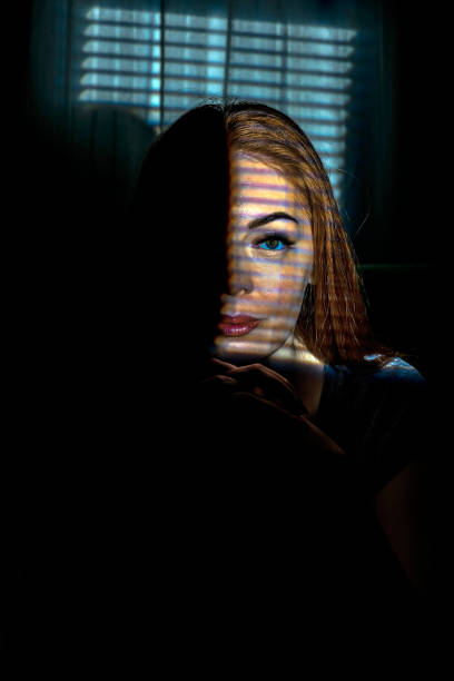 istock Woman behind the light effect like window blind or cage 1038692134