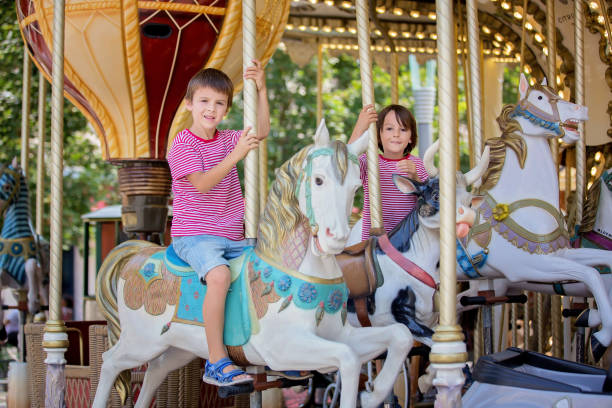 istock Children going on Merry Go Round, kids play on carousel 1038699852