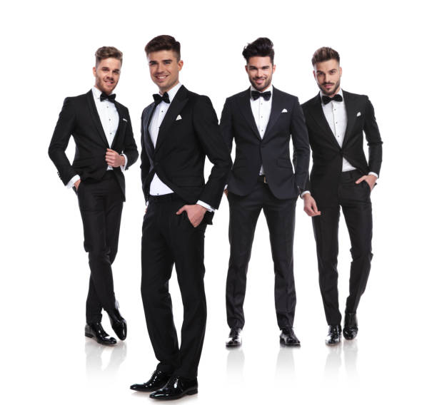 istock four elegant men in tuxedoes standing with hands in pockets 1038703672