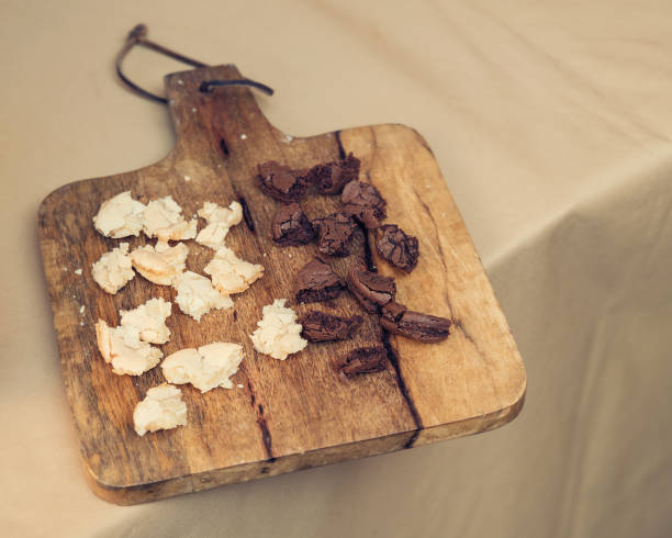 istock Vanilla and chocolate macarons tasting on wooden cutting board 1038716258