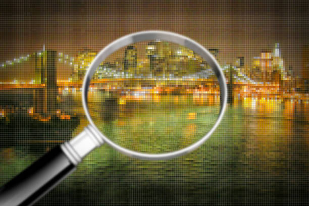 istock Getting to know Manhattan - Concept image seen through a magnifying glass with pixelation effect - Manhattan waterfront with Brooklyn Bridge at night - New York City (USA) 1038720742
