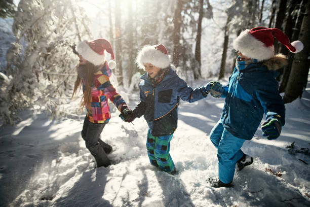 istock Kids enjoying winter forest on Christmas 1038722304