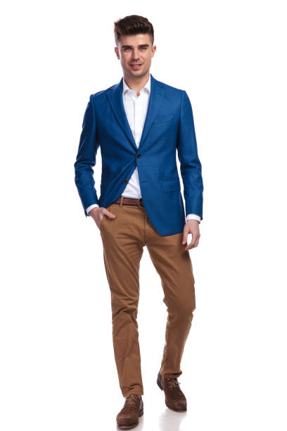 young smiling man standing with one hand in pocket