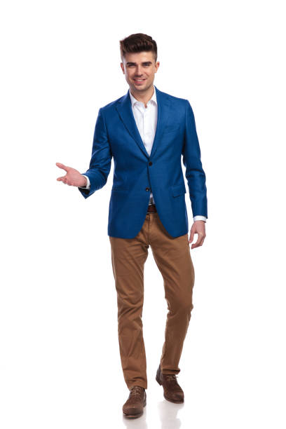 istock young smart casual man welcoming 1038728960