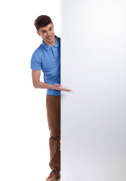 istock smiling casual man presenting a blank board 1038729710
