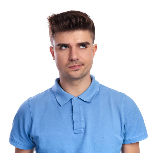 istock young casual man thinks and looks up to side 1038729778