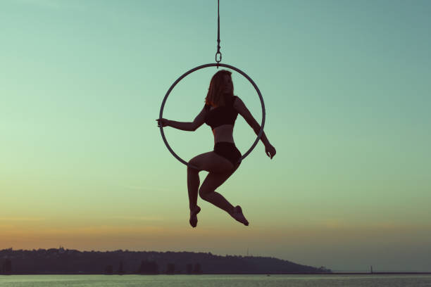 istock Girl gymnast sits on an acrobatic ring. 1038730658