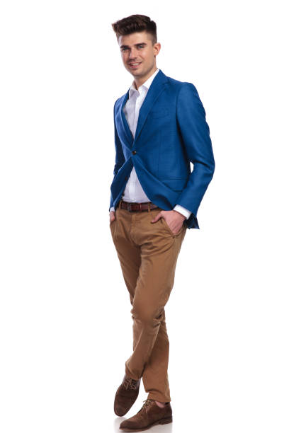 istock smiling young man standing with hands in pockets 1038731058