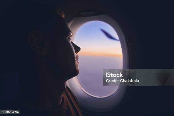 Man Traveling By Airplane Stock Photo - Download Image Now - Airplane, Window, People