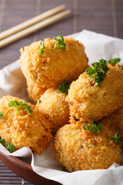 istock Japanese food: potato croquettes close-up. vertical 1038735332