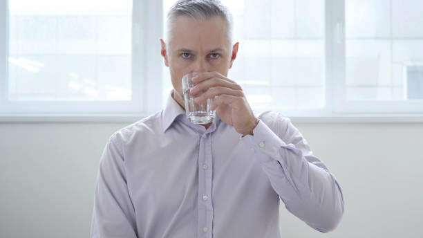 istock Businessman Drinking Water in Office 1038735884