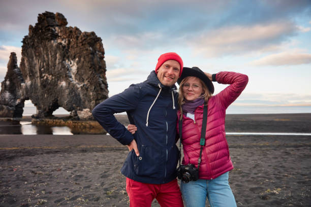 istock Couple on the black beach. Admiring the view 1038739052