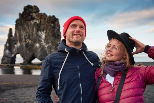 istock Couple on the black beach. Admiring the view 1038739086