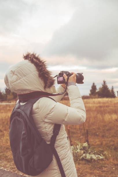 istock Woman using DSLR in mountain / suburb surroundings. 1038739168