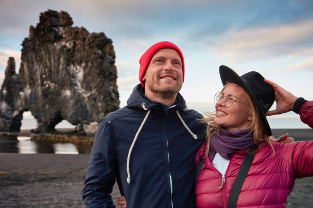 istock Couple on the black beach. Admiring the view 1038739188