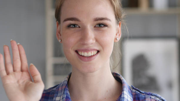 istock Hello, Young Woman Waving Hand to Welcome 1038745580