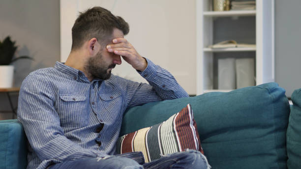 istock Tired Man Sitting with Headache, Pain 1038751118