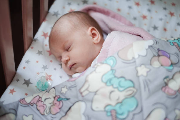 istock Baby girl sleeping in her bed. 1038752934