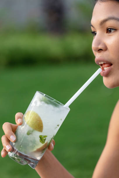 istock Asian woman drinking mojito 1038758346