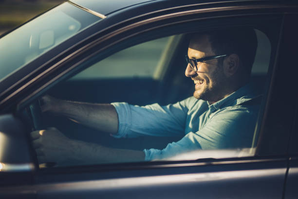 istock Young happy businessman going on a trip by car. 1038772966