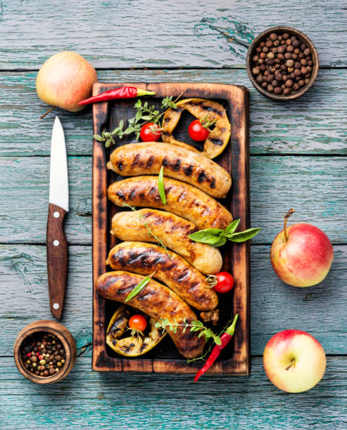 istock Sausages fried with spices and apple 1038773250
