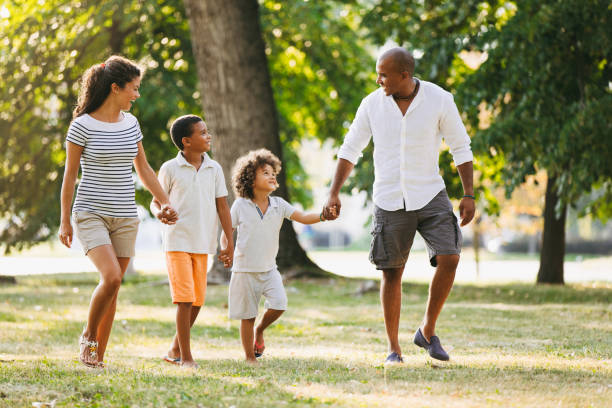 istock Happy couple spending time with their sons in the park 1038776816