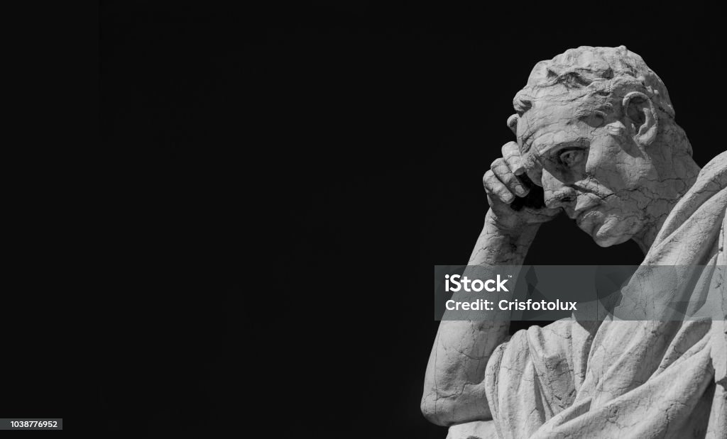 Thinking man statue (Black and White with copy space) Man statue in the act of thinking against blue sky. Ancient Roman Julian the Jurist statue made at the end of 19th century in front of the Old Palace of Justice in Rome Morality Stock Photo