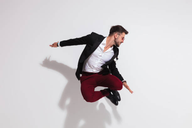 istock smart casual man jumping and looking down to side 1038809202