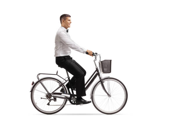 istock Young man in a tux riding a bicycle 1038814764