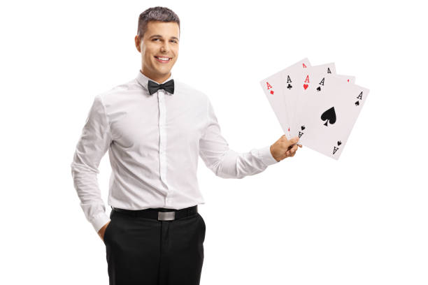 istock Handsome young man in a tux holding playing cards 1038814858
