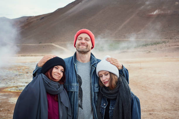 istock Three friends visiting Hverarond Geothermal Area. Posing for a photo 1038829344