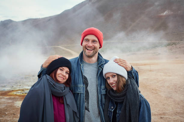istock Three friends visiting Hverarond Geothermal Area. Posing for a photo 1038830080