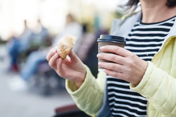 paper coffee cups in women's hands, breakfast to go