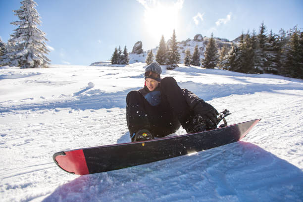 istock Young man snowboarding on the snowy mountain 1038846904