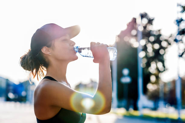 istock Woman runner drinking from water bottle 1038847096