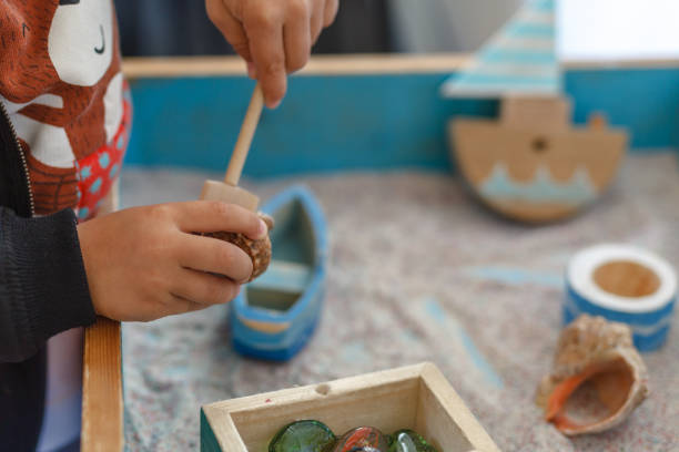 istock Autistic kid play alone with train toys 1038847638