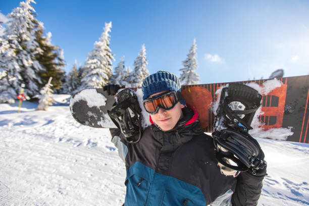 istock Young man snowboarding on the snowy mountain 1038847844