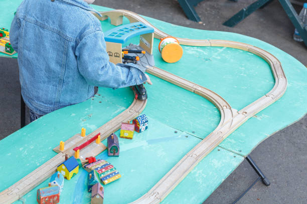 istock Autistic kid play alone with train toys 1038848014