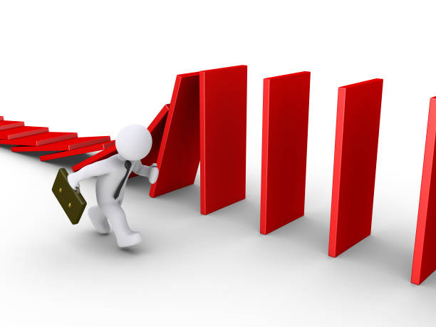 istock Businessman running beside domino 1038848424