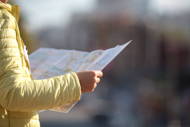 istock tourist looking at the paper map instead phone. Positive emotion. 1038849718