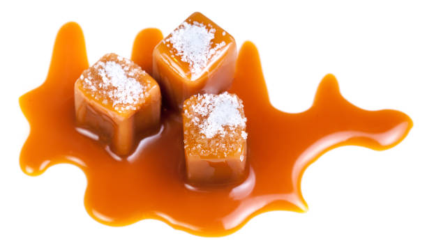 istock Caramel candies with caramel sauce and salt crystals on the top  isolated on a white background 1038856494