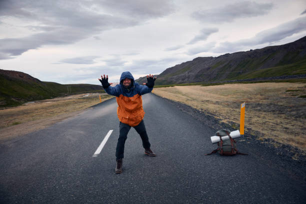 istock Travel man hitchhiking. Mountainous landscape 1038861126