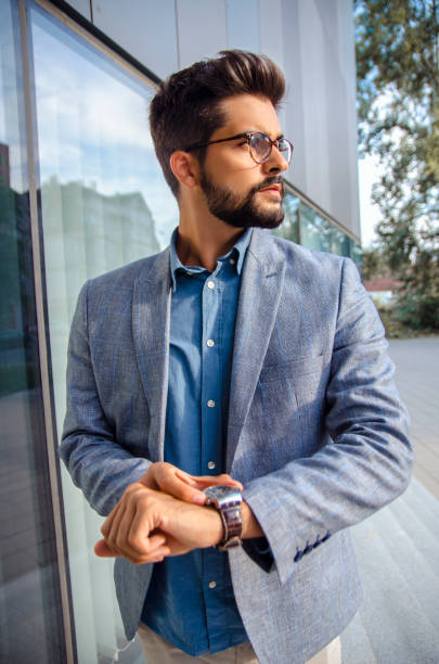 istock Handsome elegant man standing in front of office building 1038878706