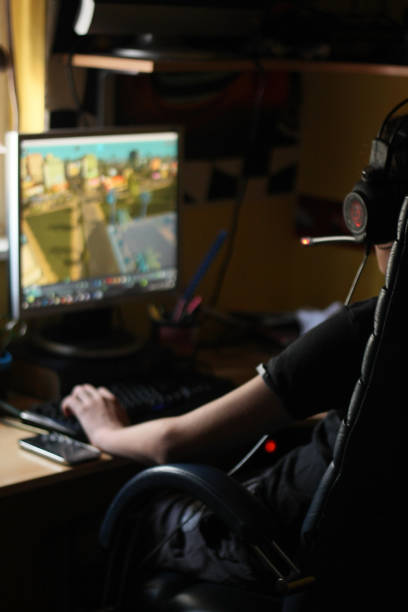 istock Teenage boy playing games on his computer at home 1038878938