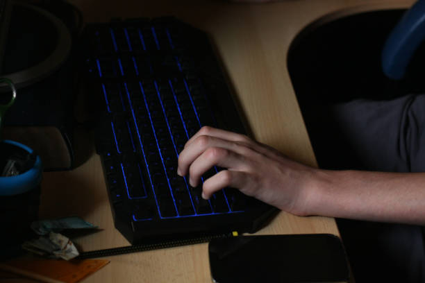istock Teenage boy playing games on his computer at home 1038878940