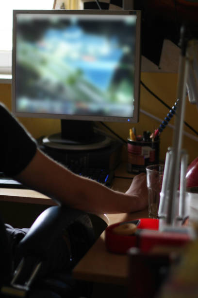 istock Teenage boy playing games on his computer at home 1038879012