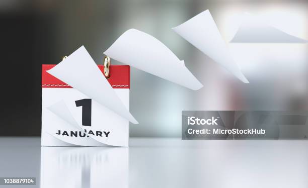 Pages Of A Red Calendar Standing Over Defocused Background Are Flying Away Stock Photo - Download Image Now