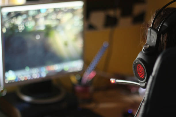 istock Teenage boy playing games on his computer at home 1038879112